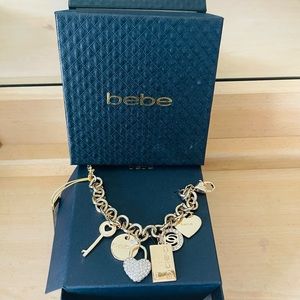 NIB - bebe gold tone charm bracelet.